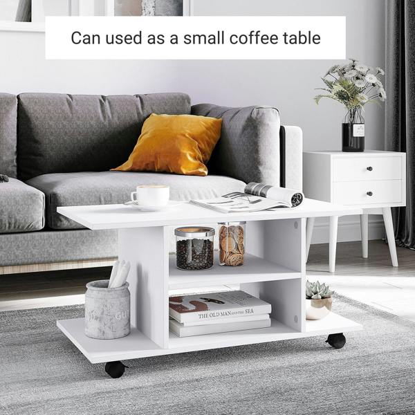 White TV cabinet stand used as a coffee table with open storage shelves and casters
