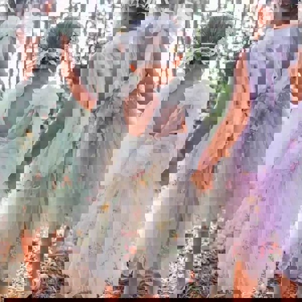 3 young girls wearing pretty dresses