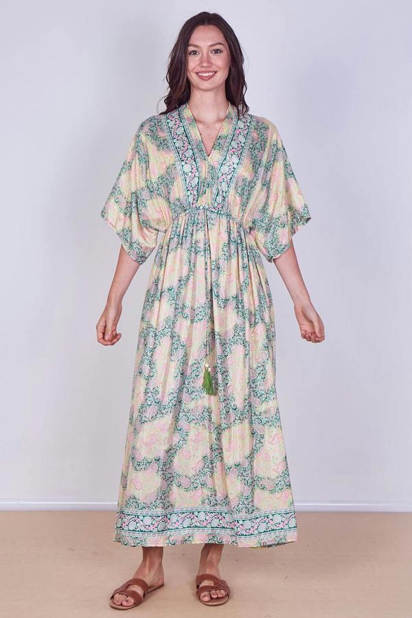 Woman wearing a floral dress against a plain background