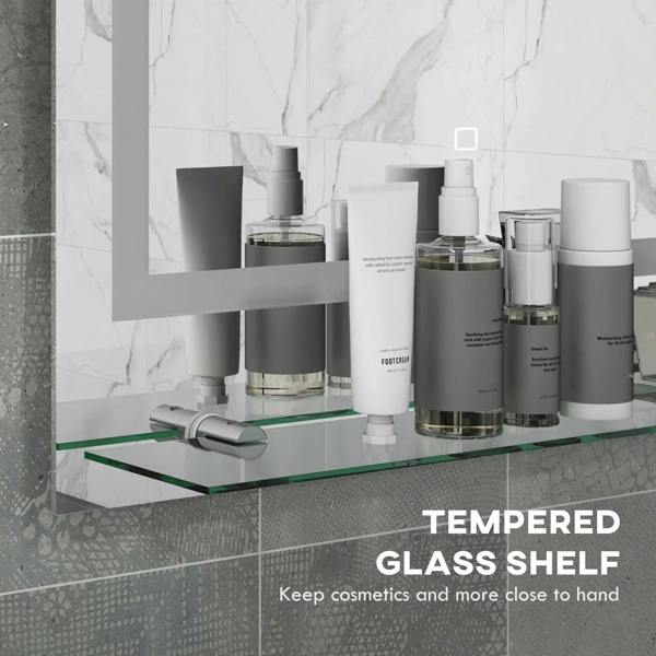 Illuminated bathroom mirror with LED border and tempered glass shelf holding toiletries