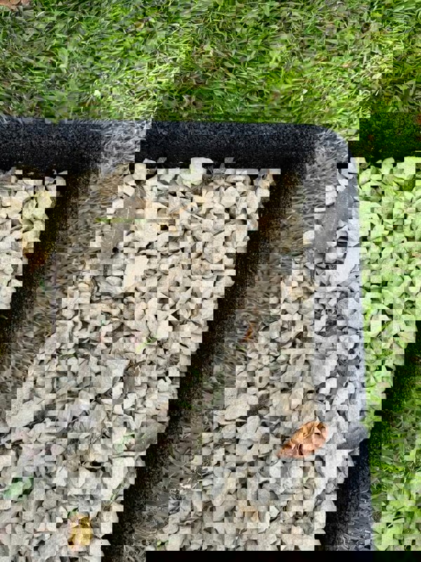 Black Flexiborder in a garden edging the lawn and stones