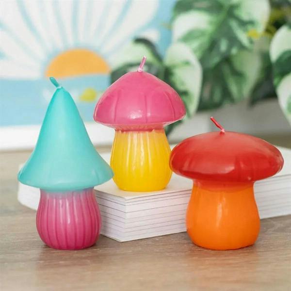 Set of 3 mushroom-shaped candles in teal, pink, yellow, and orange with red wicks
