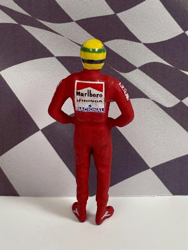 a toy figure of a man wearing a red uniform