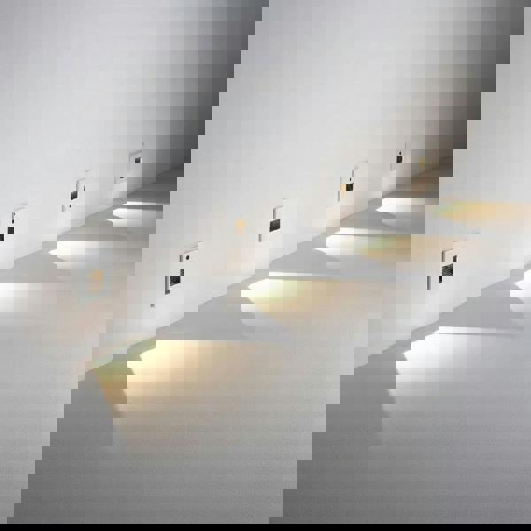 white led stair light with motion sensor mounted at low level along and indoor wall 