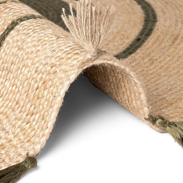 Close-up of a woven mat with tassels on a white background