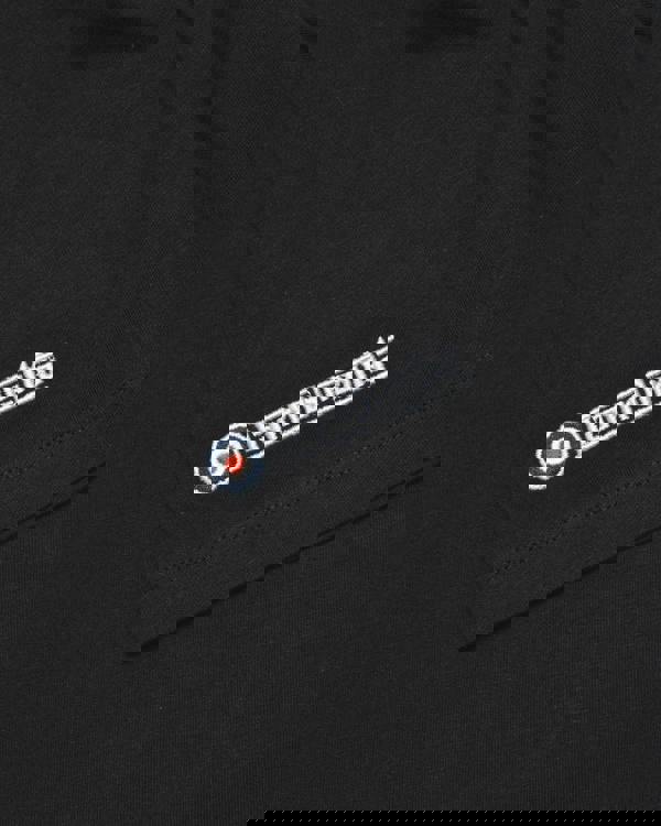 Lambretta Mens Scooter Helmet Graphic Mod Ska Casual T-Shirts, close-up of black t-shirt fabric with embroidered Lambretta logo with target symbol.