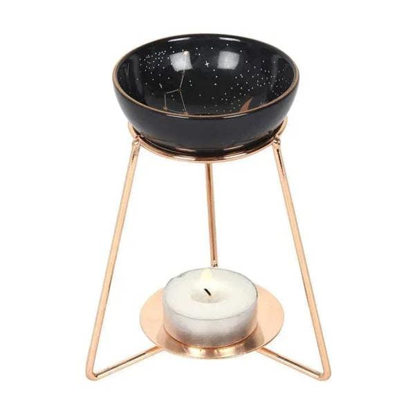 Starry black oil burner with candle wick on rose-gold metal tripod base