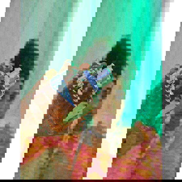 Sapil Rave Women Eau de Parfum held by model in green light