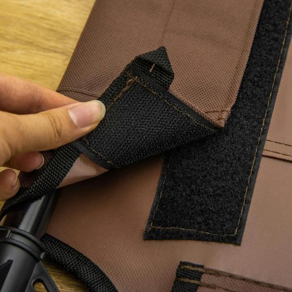 Brown pet bed cot seam close-up with black strap and fabric edge