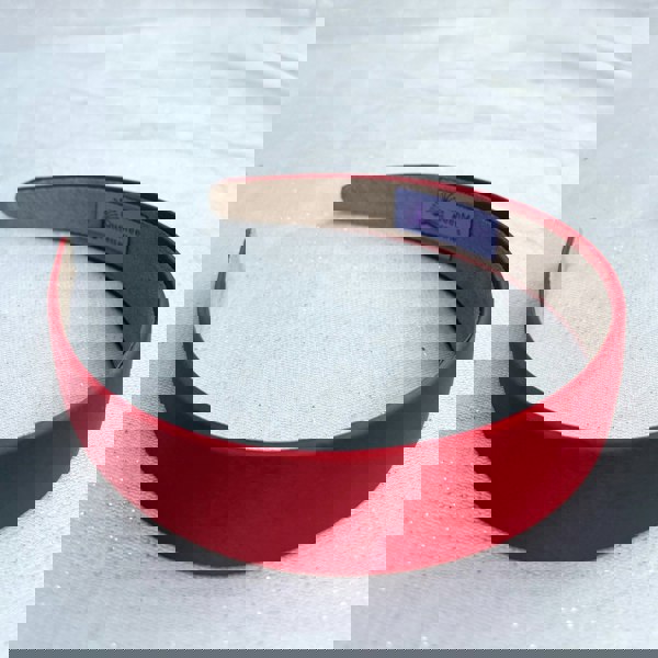 Red hairband, smooth satin finish, slim padded design, vibrant red colour, classic everyday accessory, minimalist headband style
