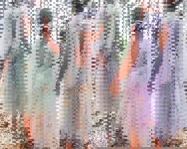 3 young girls wearing pretty dresses