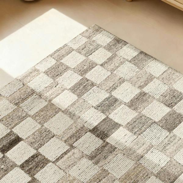 Checkered patterned rug on a wooden floor