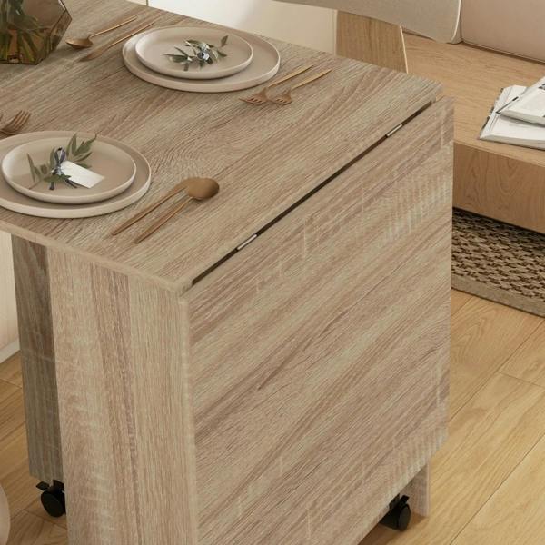 Natural wood dining table corner with smooth drop-leaf seam and rolling caster base