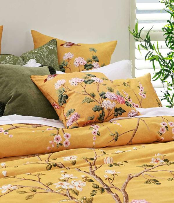 Opulent and artistic, M.M Linen Yuki design of charming blossoms and fauna on a sunny and soft, golden background