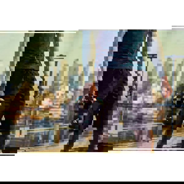 Person holding a 16kg adidas kettlebell with a cityscape in the background