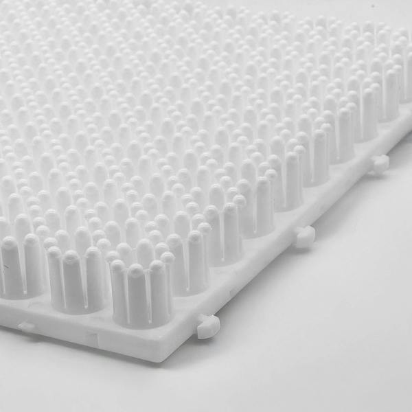 Close-up of the white ski training mat  on a light grey background