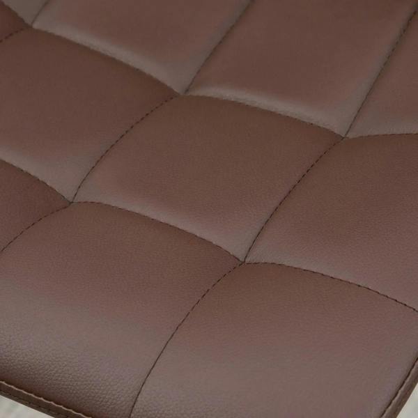 Close-up of brown tufted PU leather barstool seat and back upholstery stitching