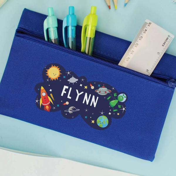 A vibrant blue zippered pencil case printed with a space scene containing rockets, planets, and the custom name "FLYNN" in white uppercase letters.