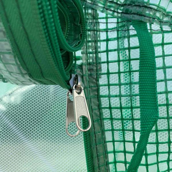 Green greenhouse door with zipper and metal latch on mesh frame