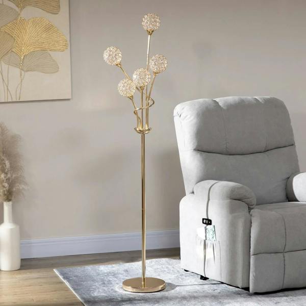 Gold-tone crystal floor lamp standing beside recliner with five round shades and base