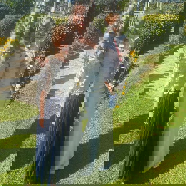 Bride and flower girl in gardens