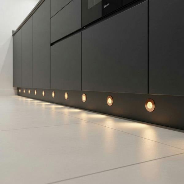 rose gold kitchen kickboard lights mounted along a dark kitchen kickboard