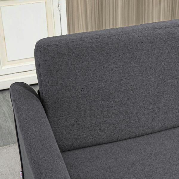 Dark grey upholstered armrest and backrest of a compact loveseat sofa