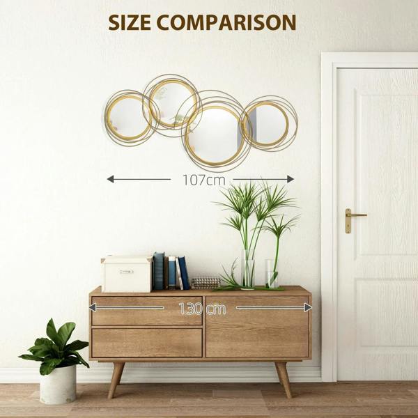 Gold-tone metal wall mirror set on wall, 107 cm wide, five circular ring frames