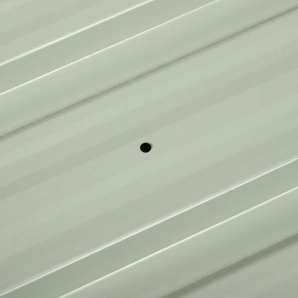 Light-colored corrugated steel roof panel with a round mounting hole
