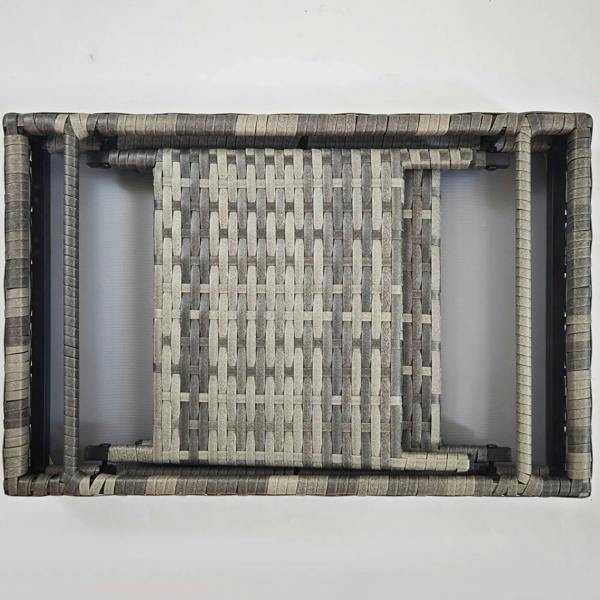 Folded grey rattan side table frame with hinged supports and woven panel