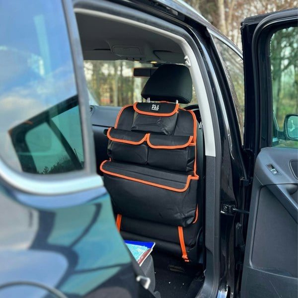 The Rear Single Seat Storage Organiser in Orange by OLPRO attached to the front drivers seat of a VW vehicle.