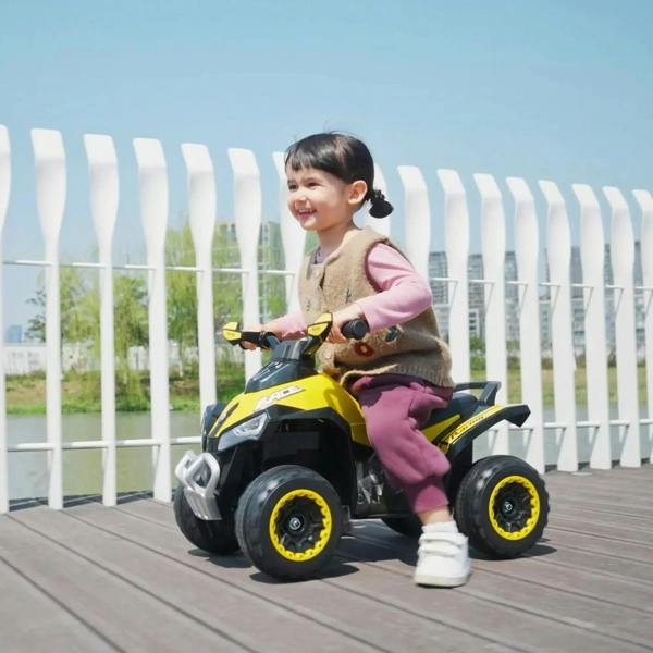 Toddler sitting on yellow ride-on car walker with black seat and front guard bar