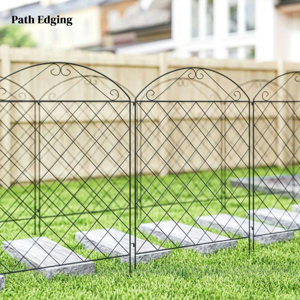 Black metal fence panels with arched tops and diamond mesh for path edging beside grass