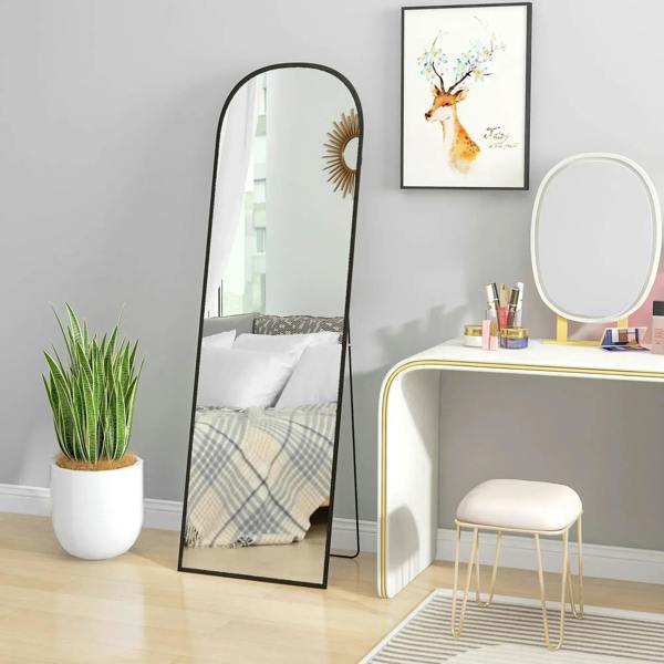 Black arched full-length standing mirror with slim frame and clear reflection