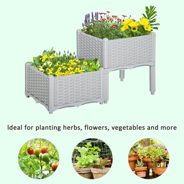 Two grey rattan-effect planters on legs filled with colorful flowers