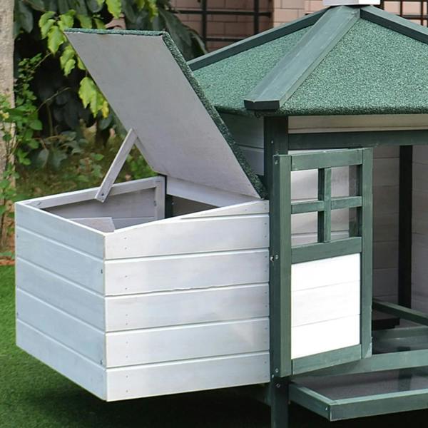 Green and white chicken coop nesting box with open ramp and raised doorway