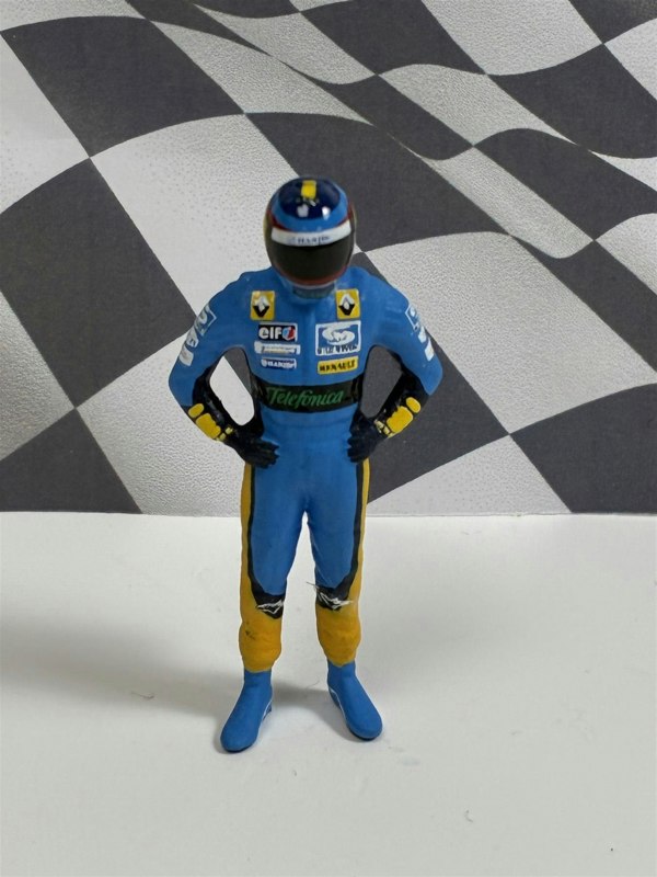 a toy figure of a race car driver