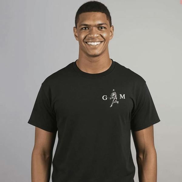 A smiling man wearing a black unisex t-shirt featuring a white silhouette of a rugby player running with a ball, personalised with the initials "G" and "M" on either side.