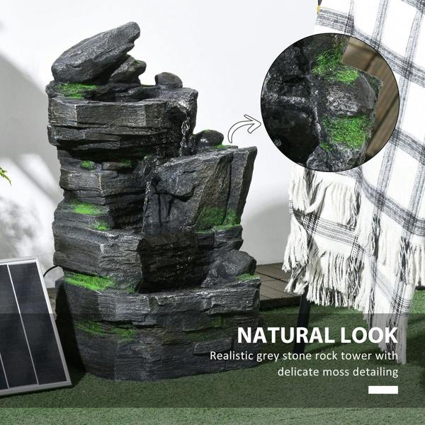 Dark grey rock water fountain with green moss detailing