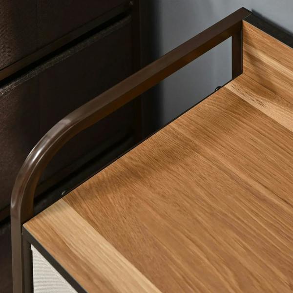 Wood tabletop corner with curved steel side rail on dark frame, close-up