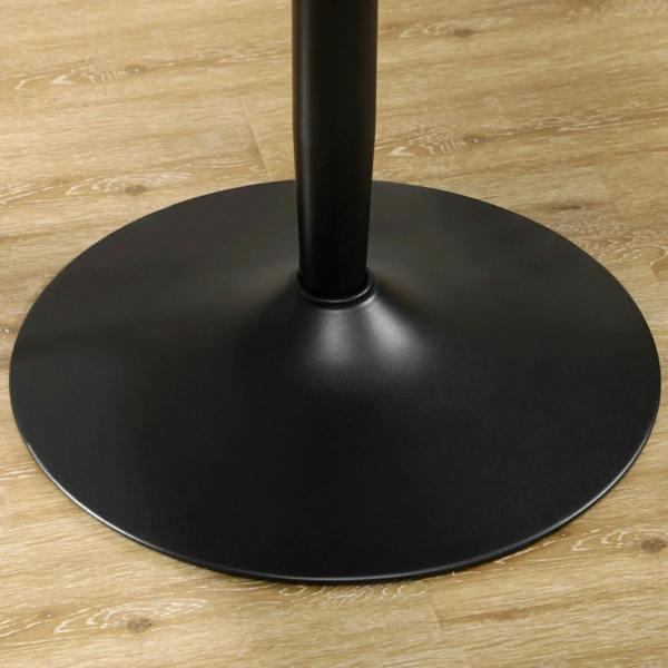 Black round pedestal dining table base with central leg on flat floor surface