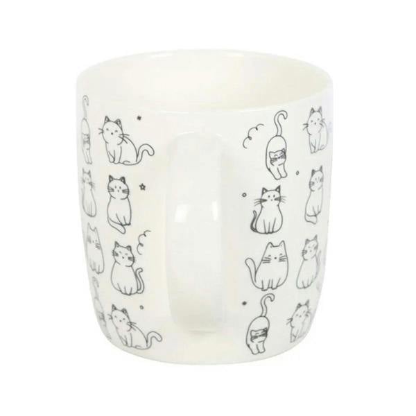 White ceramic mug with kitten line art wraparound, minimal front view, curved handle
