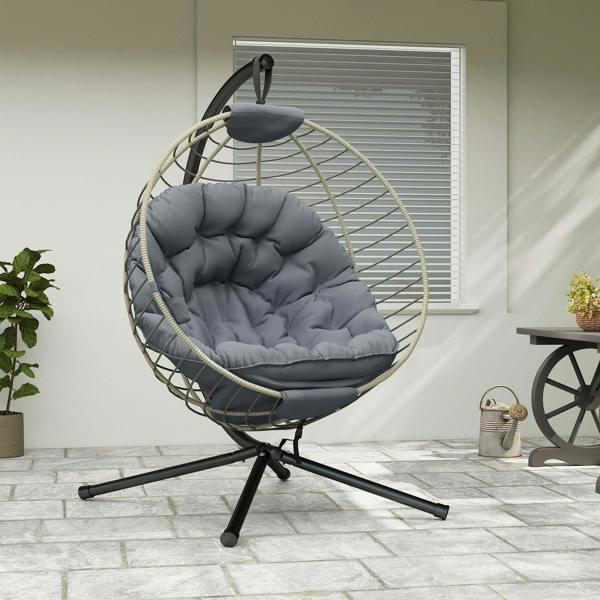 Grey hanging rattan swing chair with metal stand and tufted padded cushion