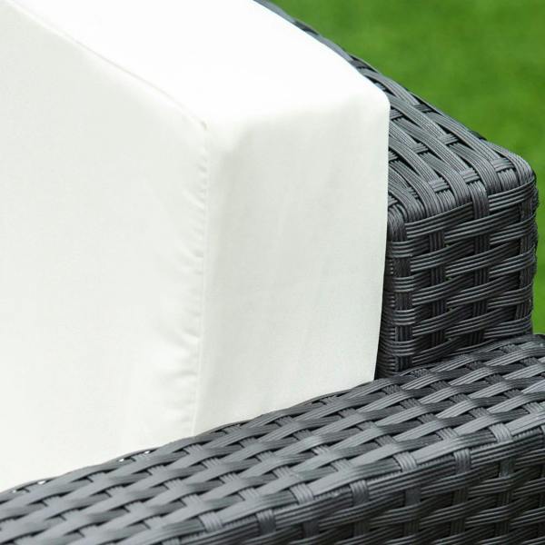 Black rattan wicker corner detail with cream seat cushion