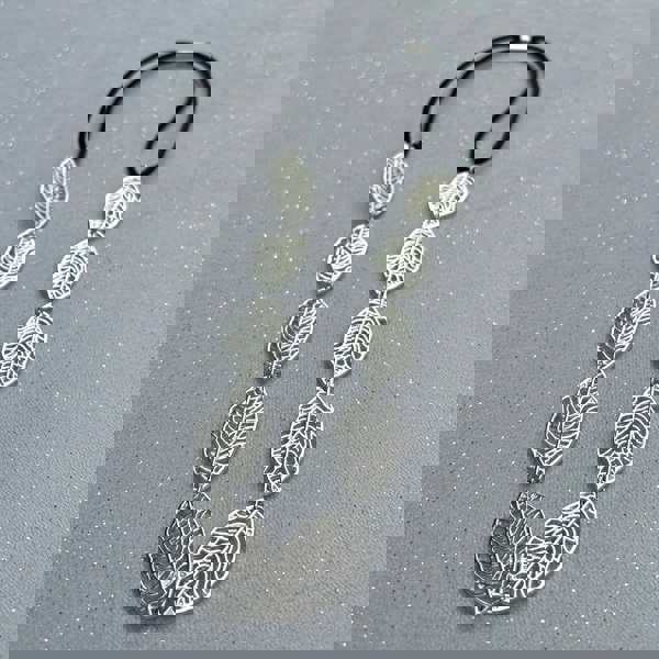 Leaf headband, silver tone metal leaves with cutout detailing, linked design, black elastic fastening for secure fit, nature inspired accessory, elegant vintage style headpiece, chic statement hairband, stylish gift for her
