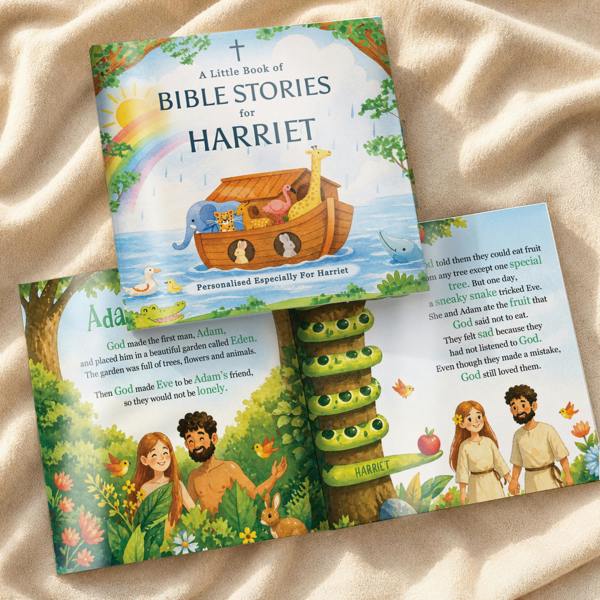 A flat lay product photograph showing a closed copy of the Personalised Children's Bible Stories Book from Abode Home & Gifts custom printed for Harriet, resting on top of an open 32-page internal double spread illustrating the story of Adam, Eve, and the Garden of Eden with the name Harriet integrated into the tree trunk design.