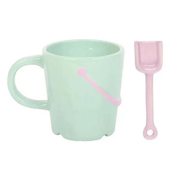 Mint bucket mug with pink spade spoon; front arrow-dot decal