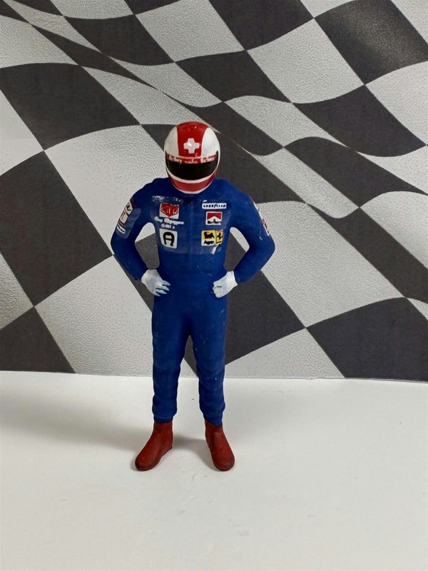 a toy figure in a race car uniform