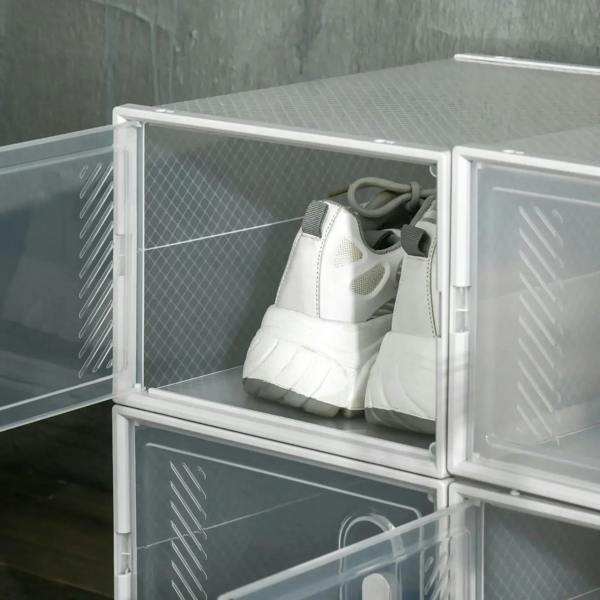 Open clear shoe storage box with magnetic door, holding a pair of sneakers