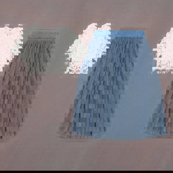 White lace top and blue pleated skirt on a gray background